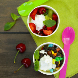 Frozen yogurt with various toppings on a table.