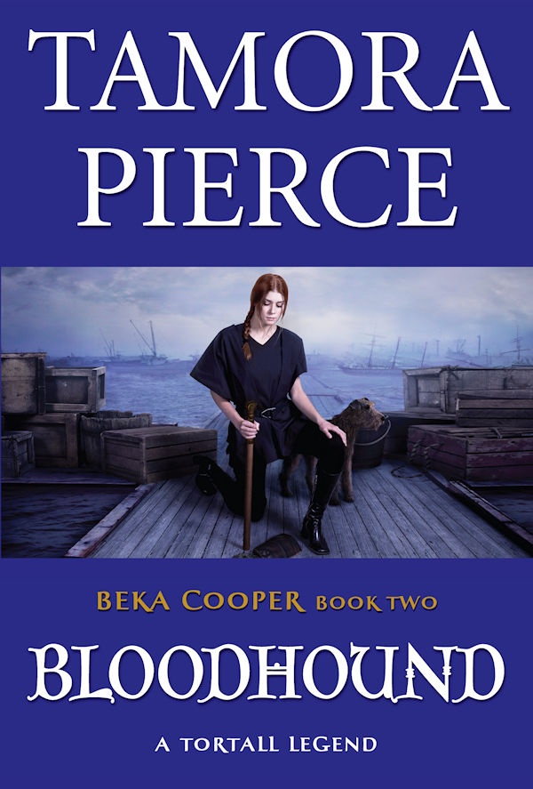 Cover of Bloodhound: Beka kneeling on a boat dock holding a bully stick with her police dog nearby.