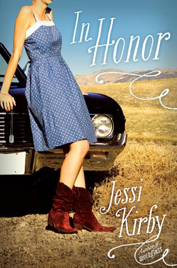 A white girl wearing a blue dress and red cowboy boots leaning against the hood of a car with a wide open landscape behind her