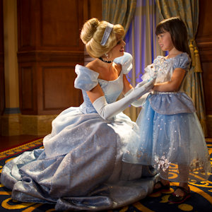 A woman playing Cinderella meeting a child