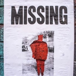 Poster that says "MISSING" with photo of red silhouette of a person