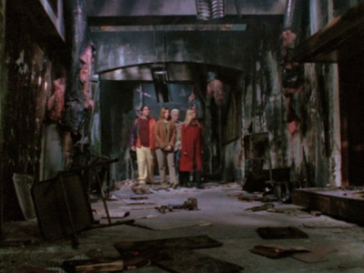 The Scooby Gang stands in the burned out shell of Sunnydale high