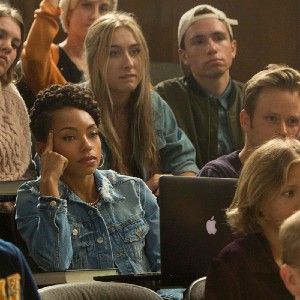 Screenshot from Dear White People, with a Black student surrounded by white students in a classroom