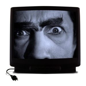 Close of of a man's crazed eyes on a black and white TV screen.