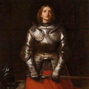 Painting of Joan of Arc, wearing a suit of armor and holding a sword while she gazes upward
