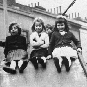 Screenshot from an installment of the Up Series, with three young girls going down a slide together