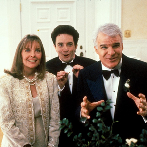 Screenshot from Father of the Bride, with Frank (Martin Short), the wedding planner, standing between the mother and father of the bride