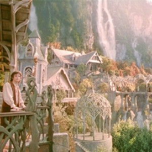 Screenshot from Lord of the Rings with Frodo looking out at a magical city