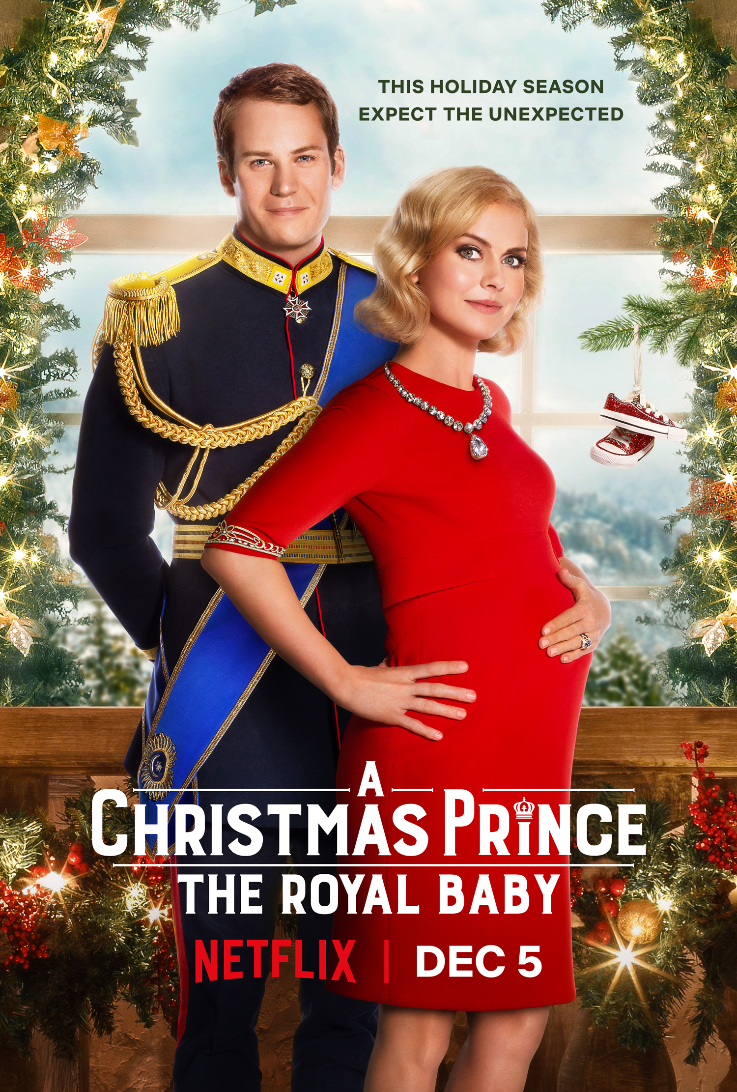 A Christmas Prince The Royal Baby Cover: A woman in red holds her pregnant stomach and her husband the prince stands behind her