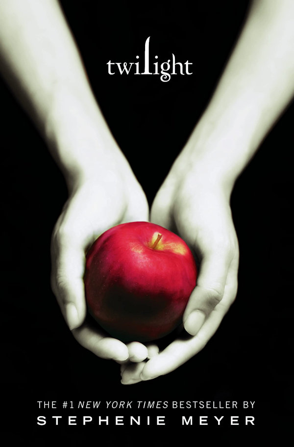 Twilight Cover: 2 hands hold a red apple on a black background