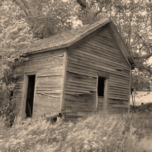 Black and white photo of an abandoned house