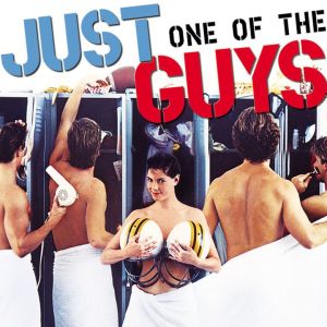 Movie poster for Just One of the Guys. A teen girl stands in a men's locker room, holding football helmets over her chest
