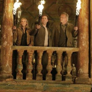 Screenshot from National Treasure, with three characters holding torches in an ancient building