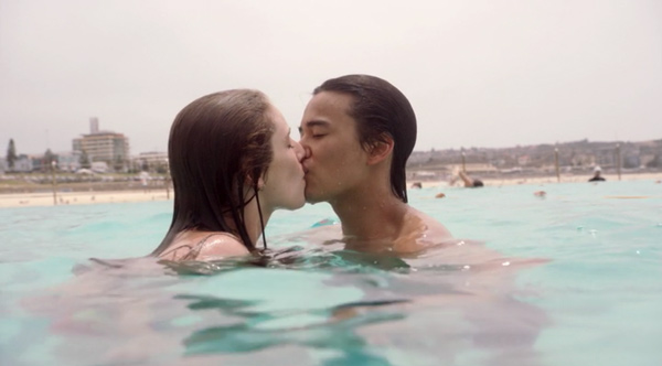 Tara and Christian kissing in the ocean
