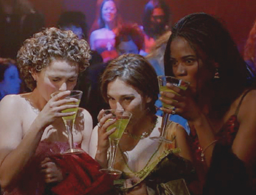 Felicity, Julie, and Elena taking cautious sips of neon cocktails at a dance club