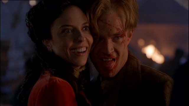 Drusilla and Spike, with blood on his face, in period garb during a flashback