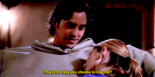 Buffy, talking earnestly to Xander, who is wearing a giant puffy suit to protect him during training