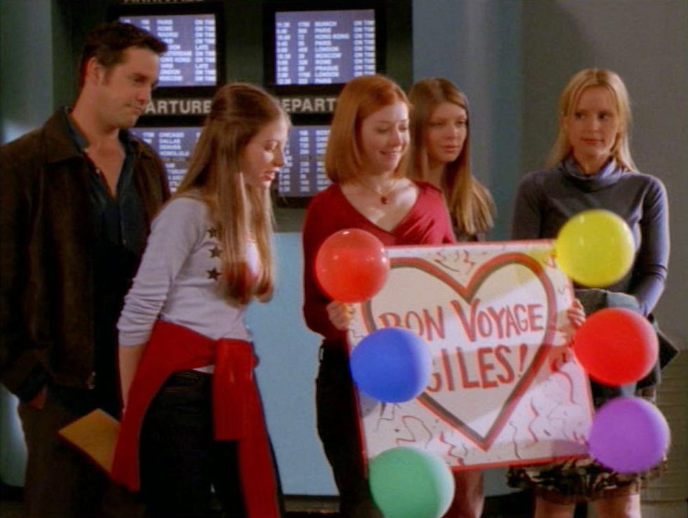 Xander, Dawn, Willow, Tara, and Anya at the airport with a Bon Voyage Giles sign