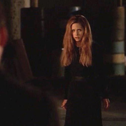 Buffy, with unkempt hair, wearing a baggy black dress