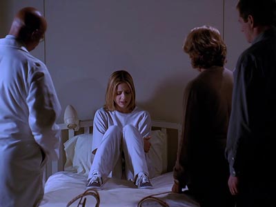 Buffy, sitting on a hospital bed surrounded by a doctor and her parents