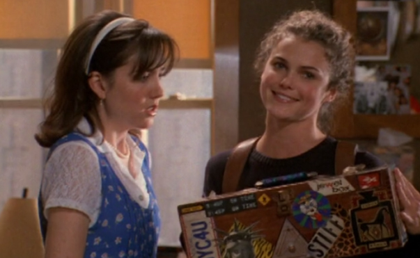 Meghan, wearing a preppy outfit, and Felicity, holding Meghan's box