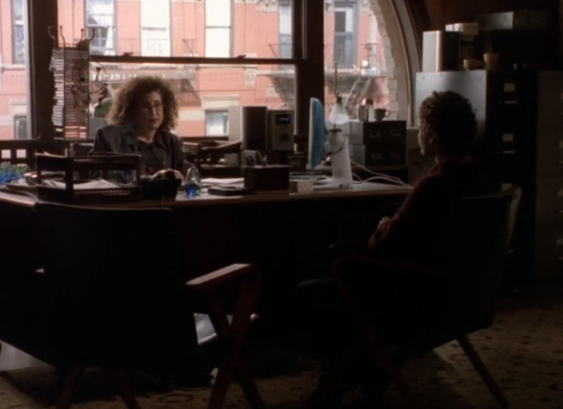 Felicity, sitting across from Dr. Pavone in her office, which has a big arch window