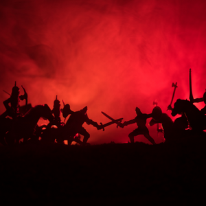 Silhouettes of a battle, with both sides yielding swords and weapons, against a bright red background
