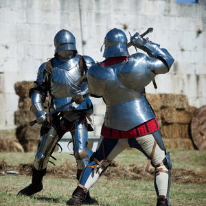 Two knights in full armor spar with swords