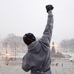 Rocky Balboa raises his fist in victory at the end of a training montage