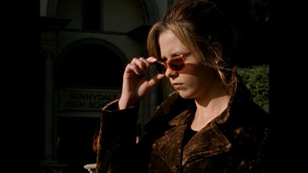 Buffy lowers her sunglasses
