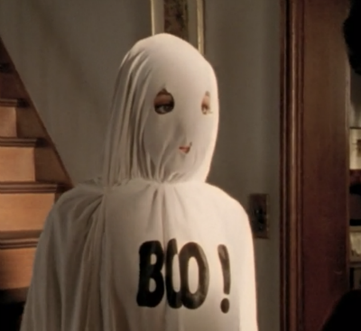 Willow in a sheet that says Boo