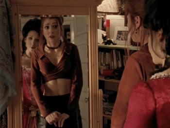 Willow in a revealing midriff top and mini shirt looking uncomfortable