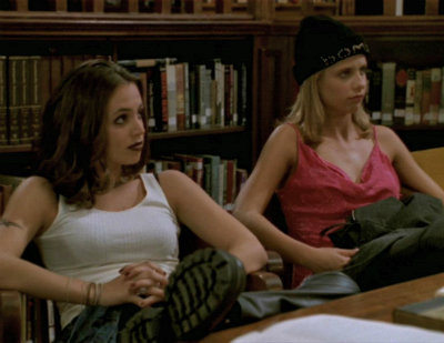 Faith and Buffy sit in the library