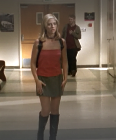 Buffy wearing a silky red top, gray miniskirt and knee high boots