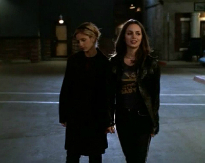 Buffy and Faith walk down a dark road at night