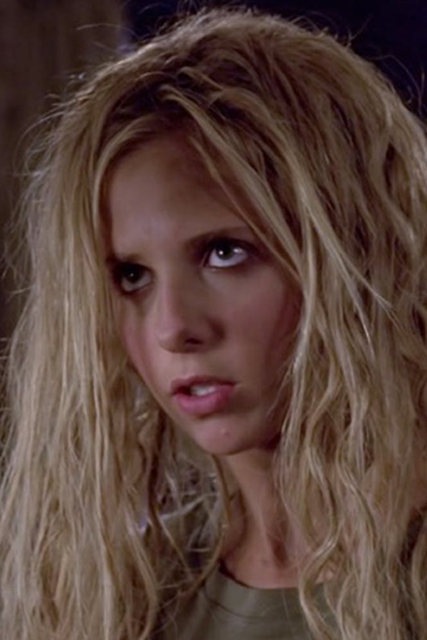 Buffy, with messy teased out hair and a dumb look on her face