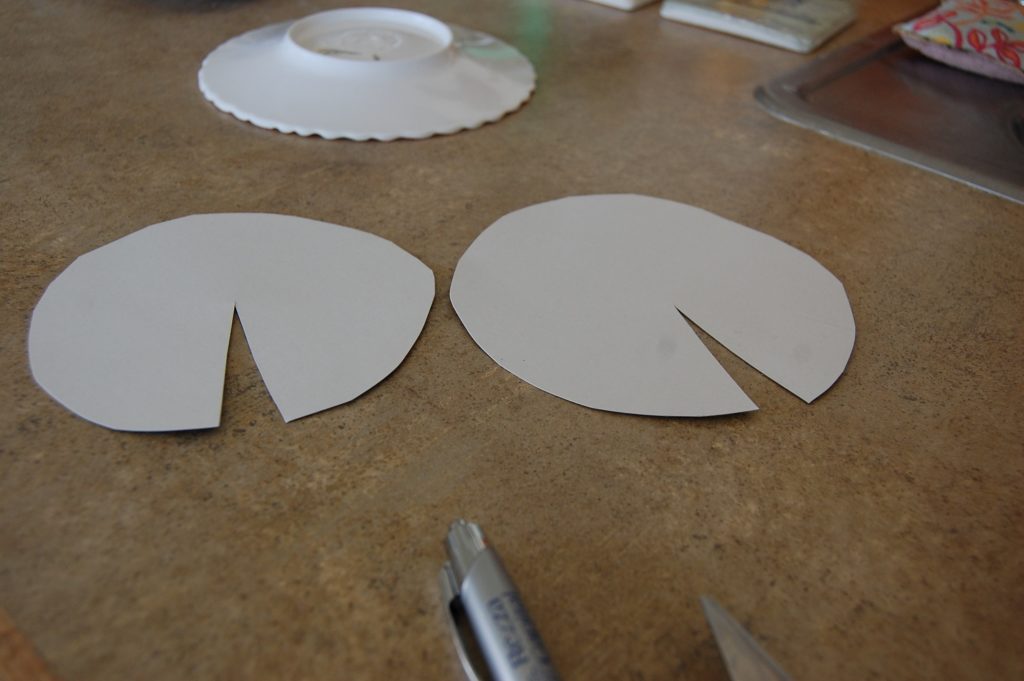 Two cardboard circles with a pie slice cut out of each