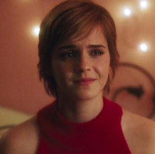 Emma Watson, with short brown hair, tearing up and wearing a red halter top