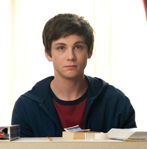 Logan Lerman as Charlie, wearing a hoodie and looking blank while sitting at a table