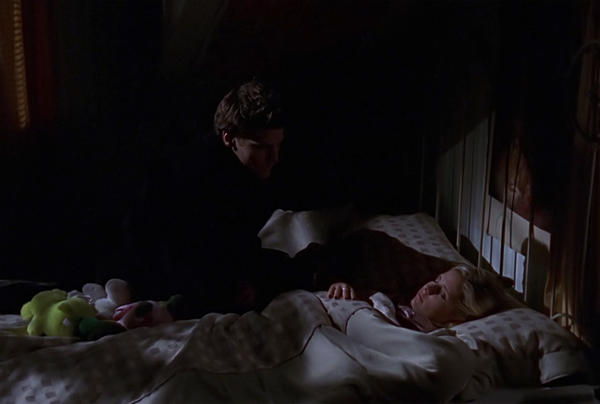 Angel crouching over Buffy's bed while she's asleep