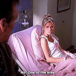 Buffy, sitting in a hospital bed talking to Giles, who is looking at a crayon drawing of a monster