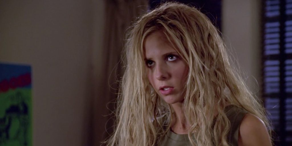 Buffy, her hair super teased and messy, with a dumb look on her face