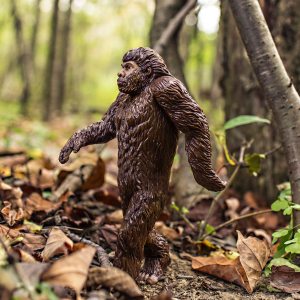 a ceramic statue of bigfoot in the woods