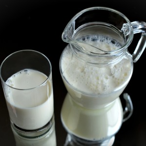 A pitcher and glass of milk
