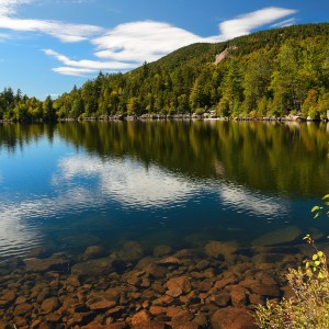 A beautiful lake surrounded by wooded mountains in the Adirondacks