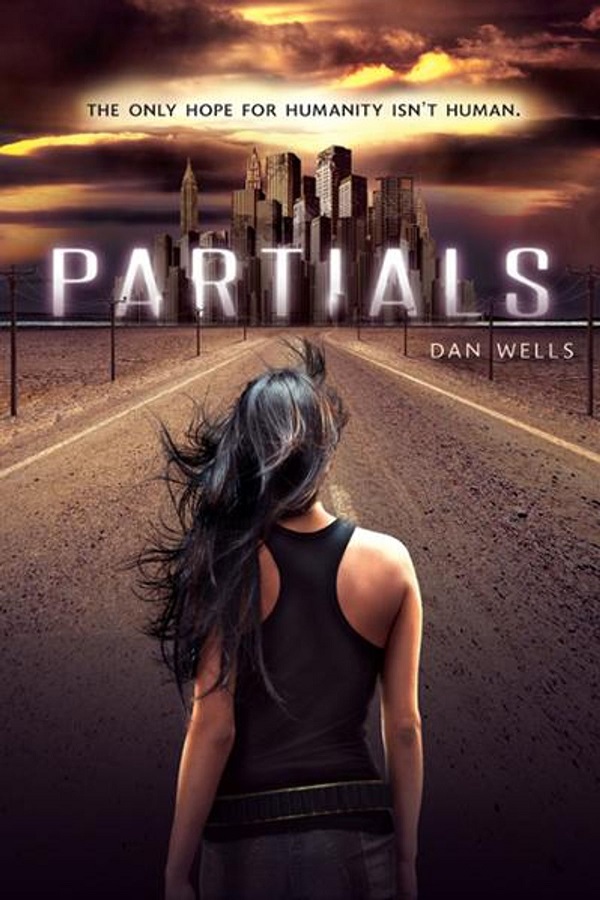 Cover of Partials by Dan Wells. A young woman with her back to the viewer walks toward a distant city at night