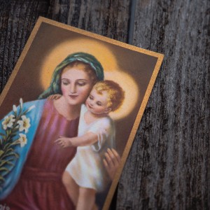 Photo of a religious card with Mary holding a baby Jesus