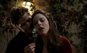 Angelus rubs a flower across Drusilla's face