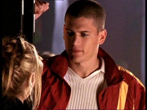 Actor Wentworth Miller leans against a door frame while talking to Buffy