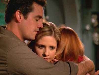 Xander and Willow hug Buffy between them